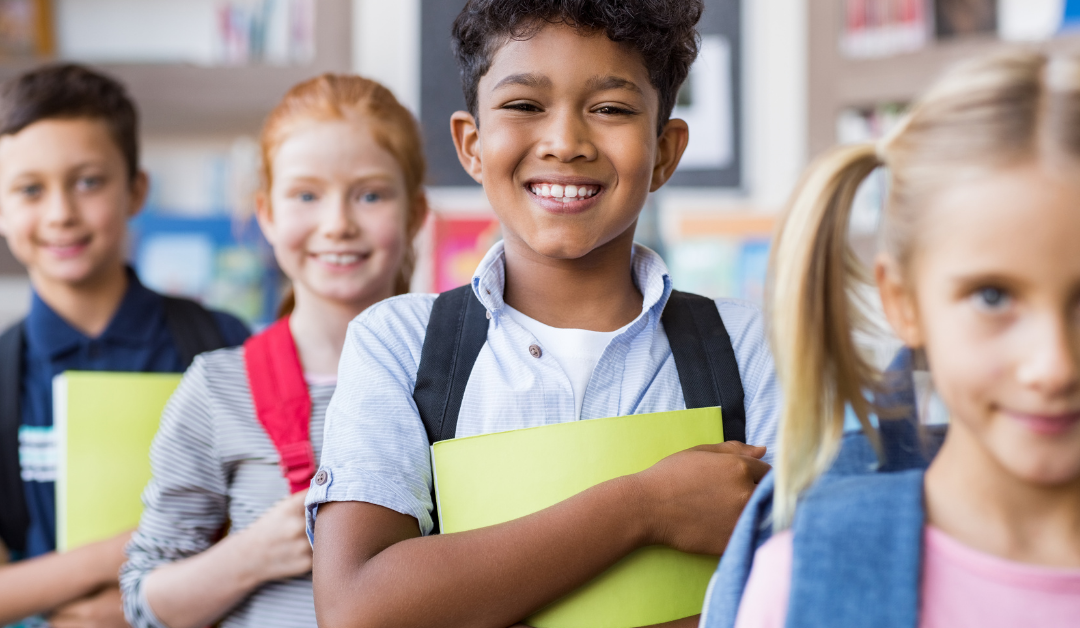 cuatro niños de la escuela alineados en una fila