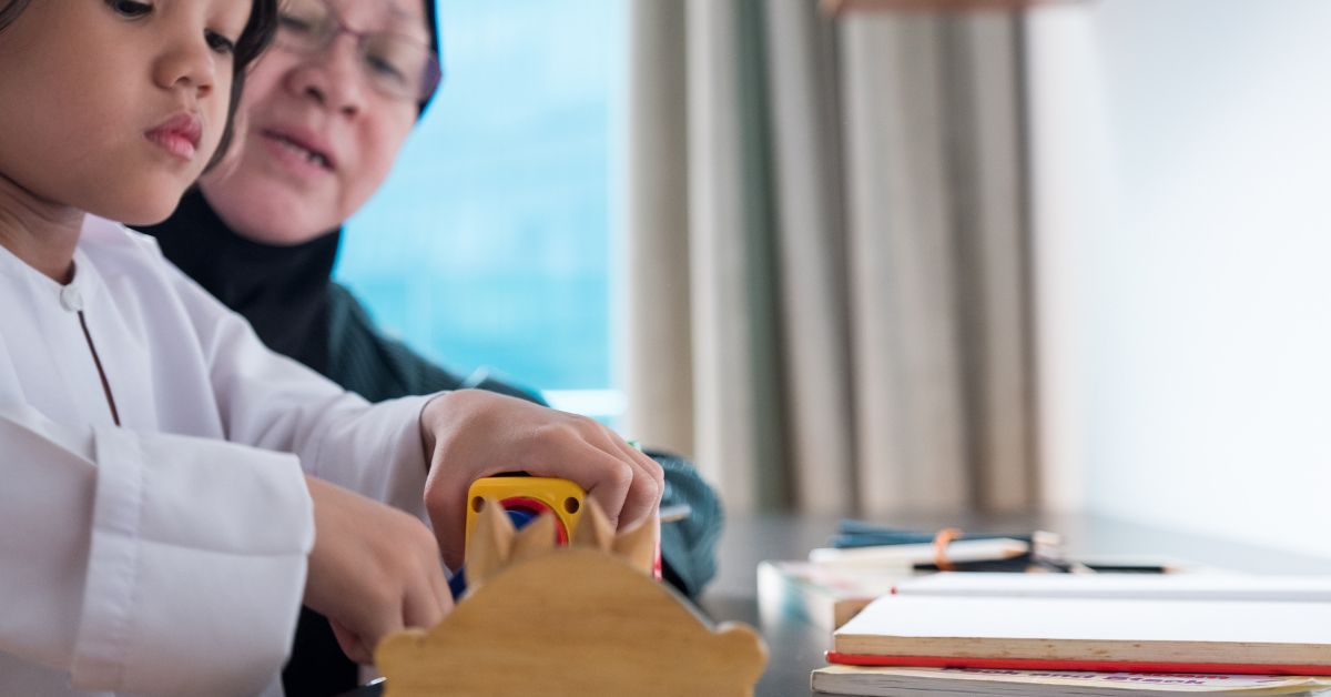 woman teaching girl to use a new toy