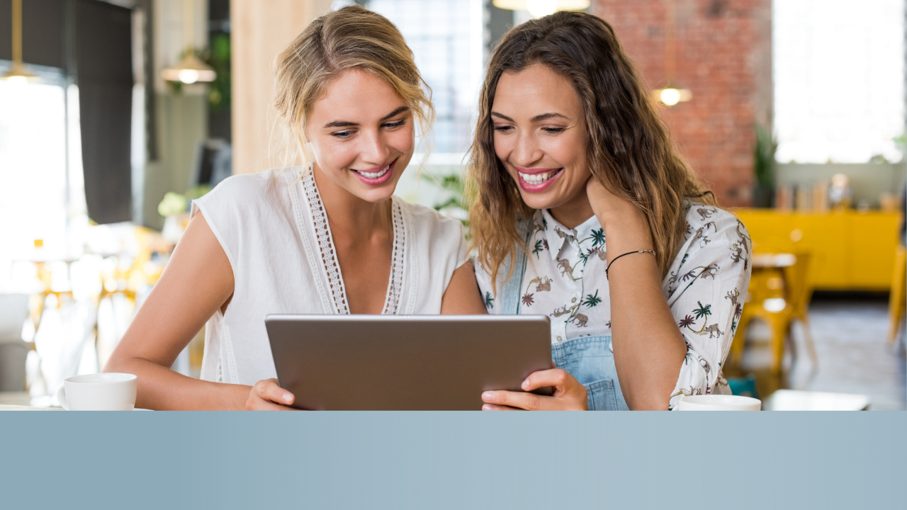 two nannies looking at a computer