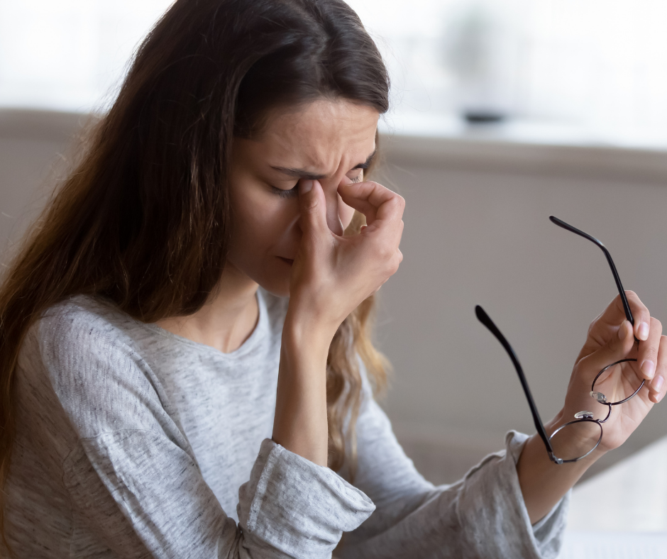 woman rubbing eyes from fatigue